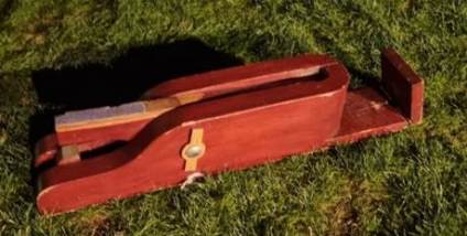 A wooden object on the grass
AI-generated content may be incorrect.